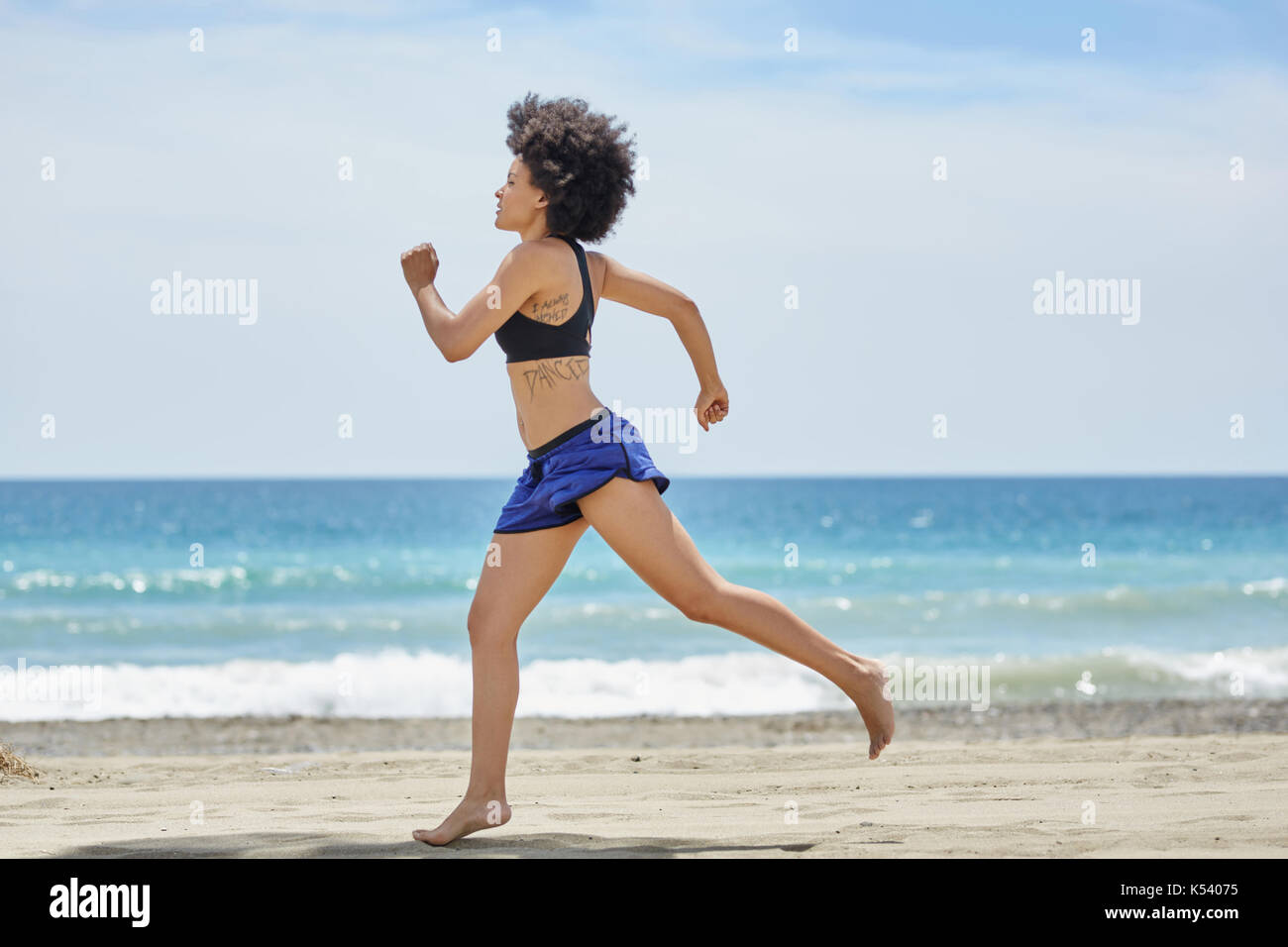 profile portrait of young afro american sportswoman training on