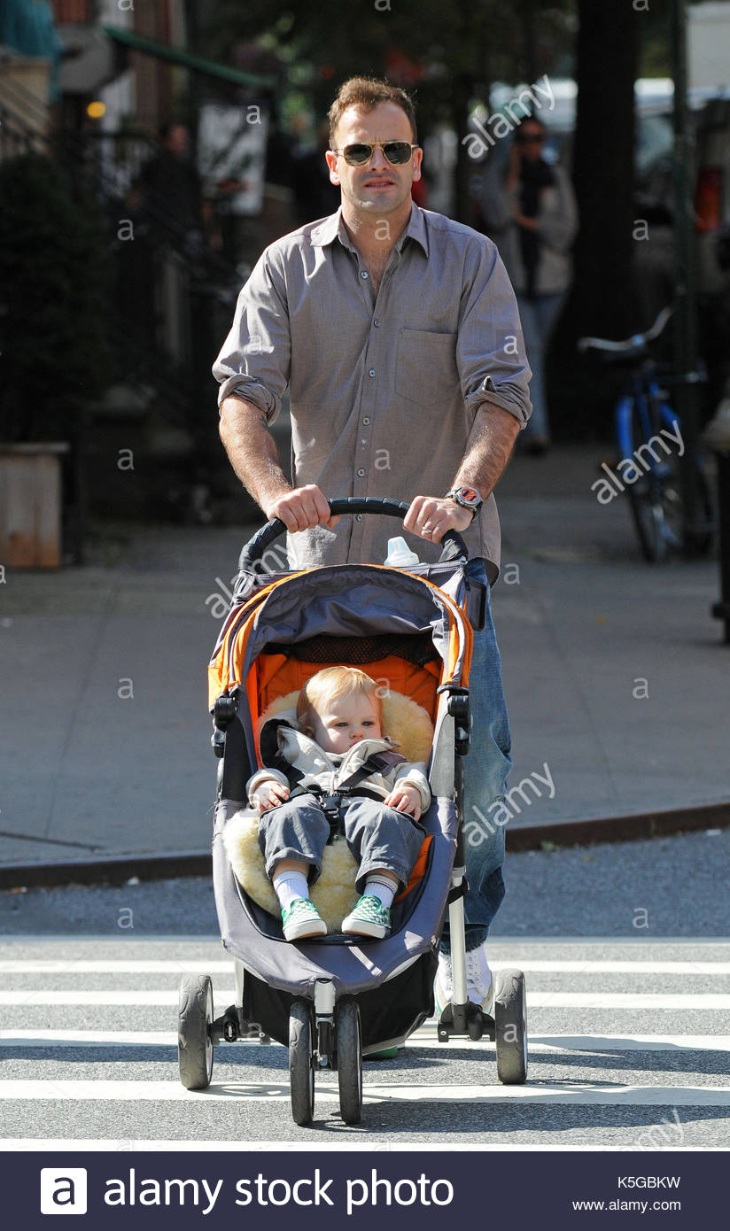 Jonny Lee Miller and Buster Timothy Miller. Sienna Miller walks in Stock Photo, Royalty Free