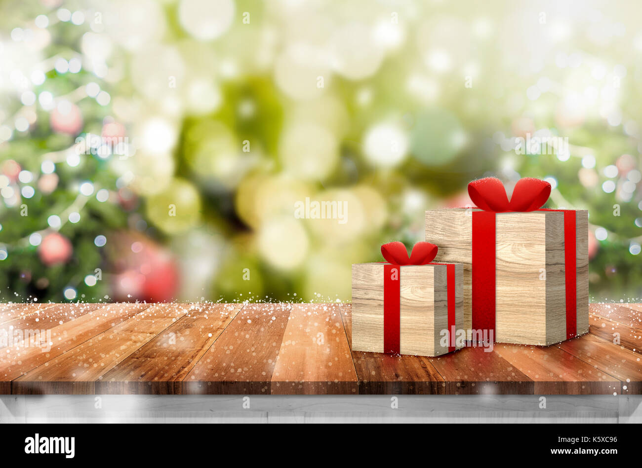 gift box on wood plank table top with abstract blur live table top christmas tree