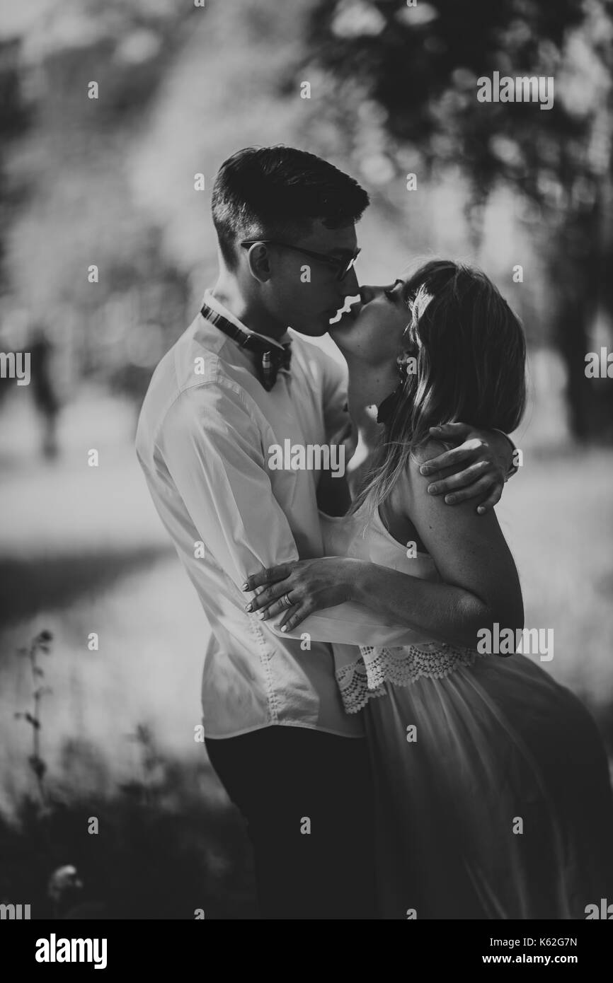Black and white photo young beautiful couple on a blurred natural