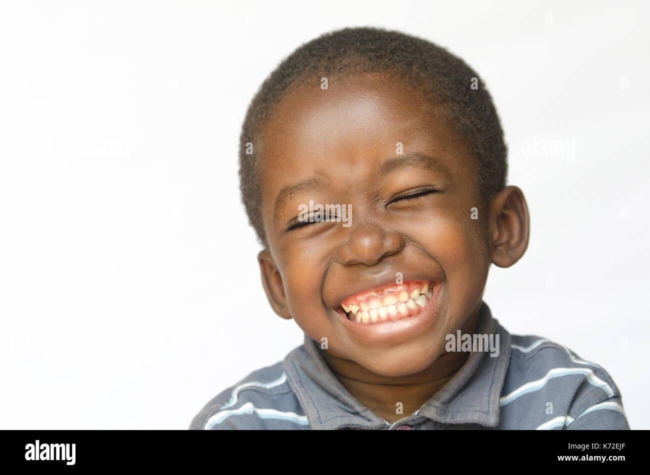 Awesome huge smile on black african ethnicity black boy child isolated on white portrait