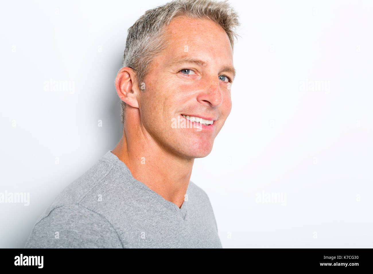 Portrait Of Confident Mature Man Standing On White Background Stock