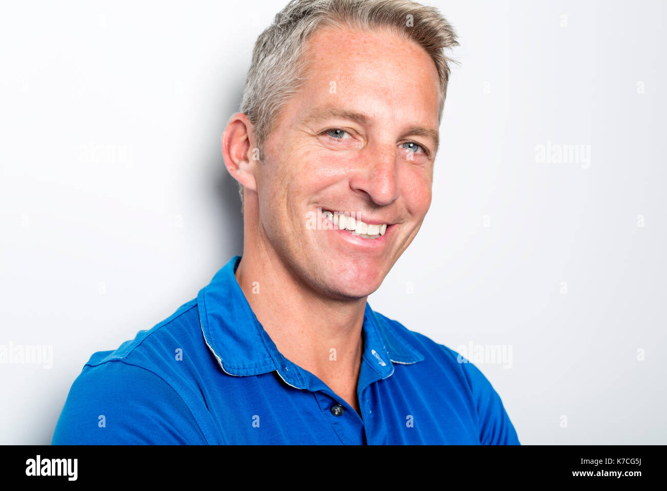 Portrait Of Confident Mature Man Standing On White Background Stock