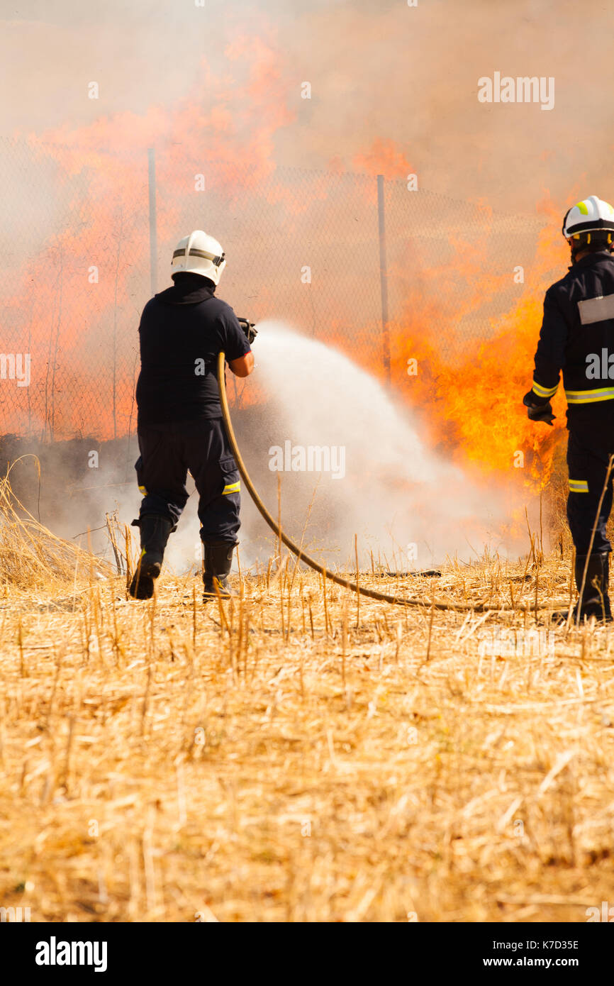 two firefighters putting out