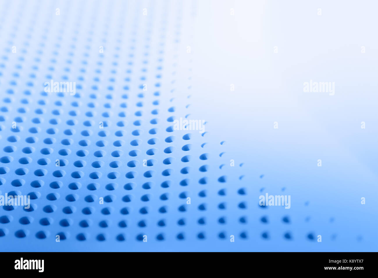 abstract light colored surface with holes built in a row for stock