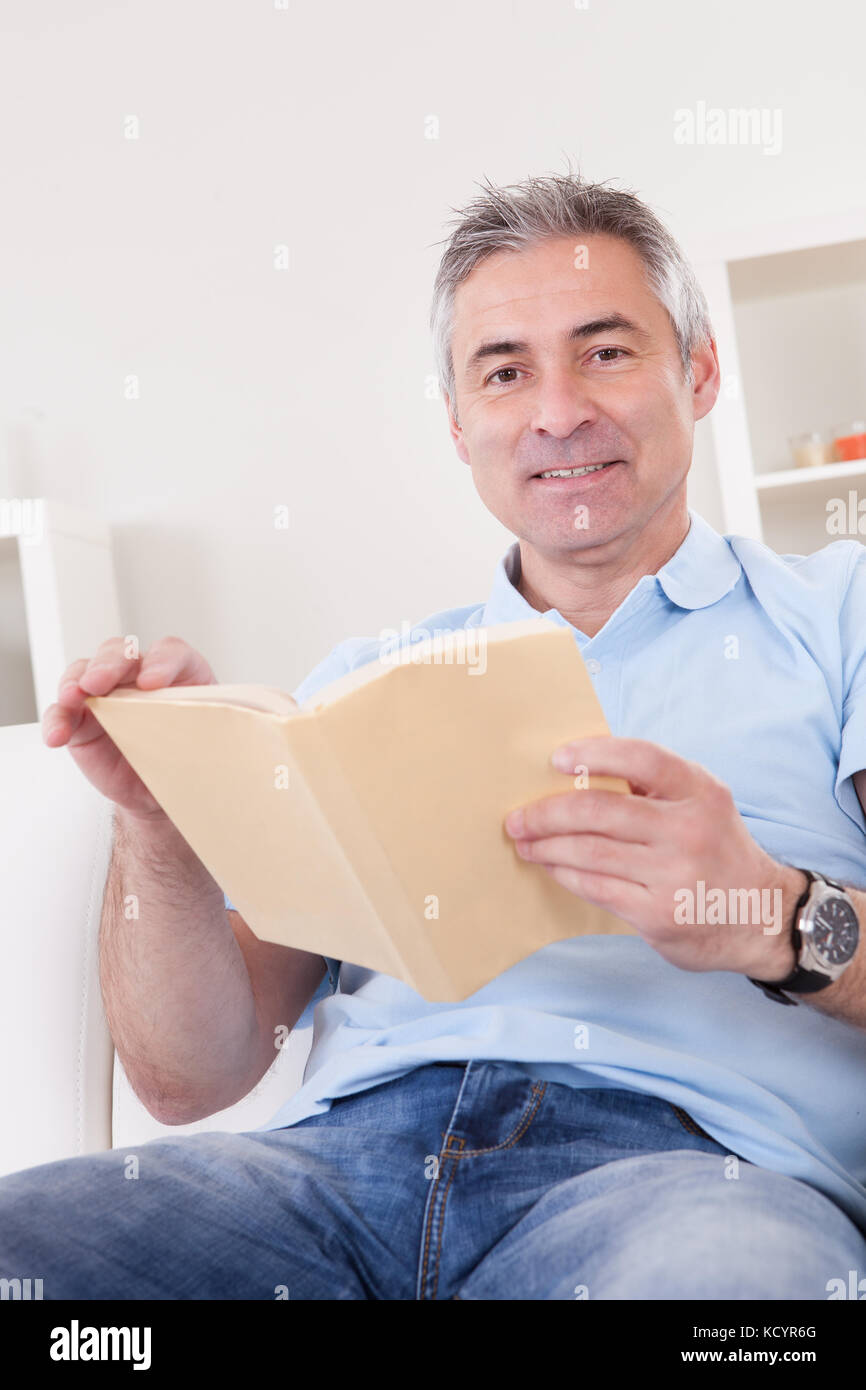 Portrait Of Happy Mature Man Reading Book Stock Photo Alamy