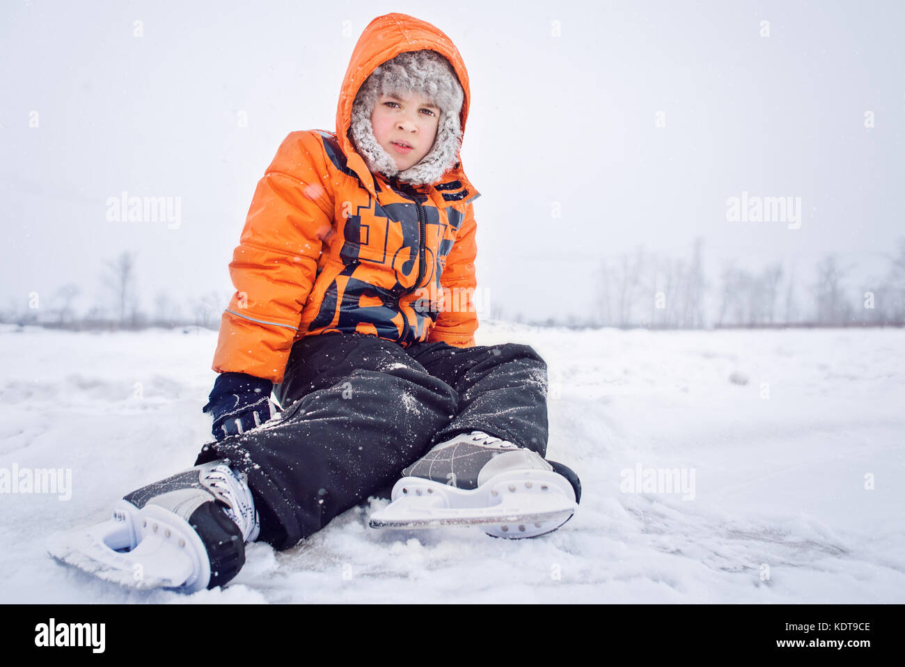 Tired At Training Exercise Boy Teen On Snow Near Skating Ice Rink In Hockey Skate Concept Of Training At Ice Tired At Training Exercise Boy Teen On Snow Near Skating Ice Rink In Hockey Skate Concept Of Training At Ice