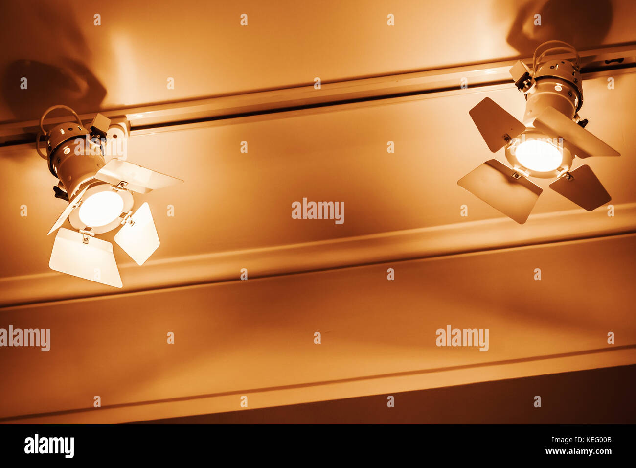 Yellow Spot Lights In Metal Body Over White Ceiling