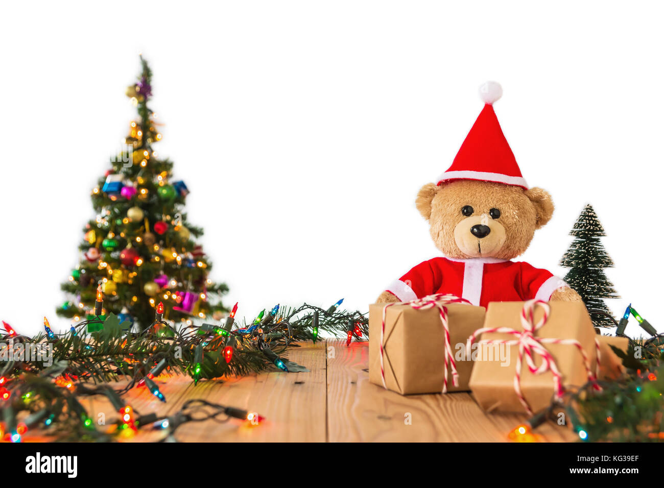 A Photo Of Teddy Bear In Santa Cross Dress With Christmas Tree Background A Photo Of Teddy Bear In Santa Cross Dress With Christmas Tree Background
