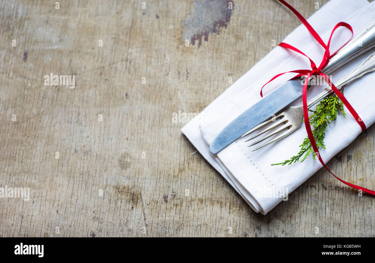 Napkin with red ribbon and vintage silverware on rustic wooden table ... Napkin with red ribbon and vintage silverware on rustic wooden table ...