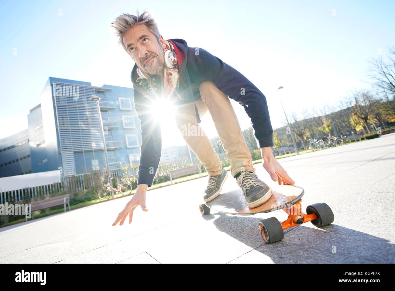 Mature Man Skateboarding In The Street Stock Photo Alamy