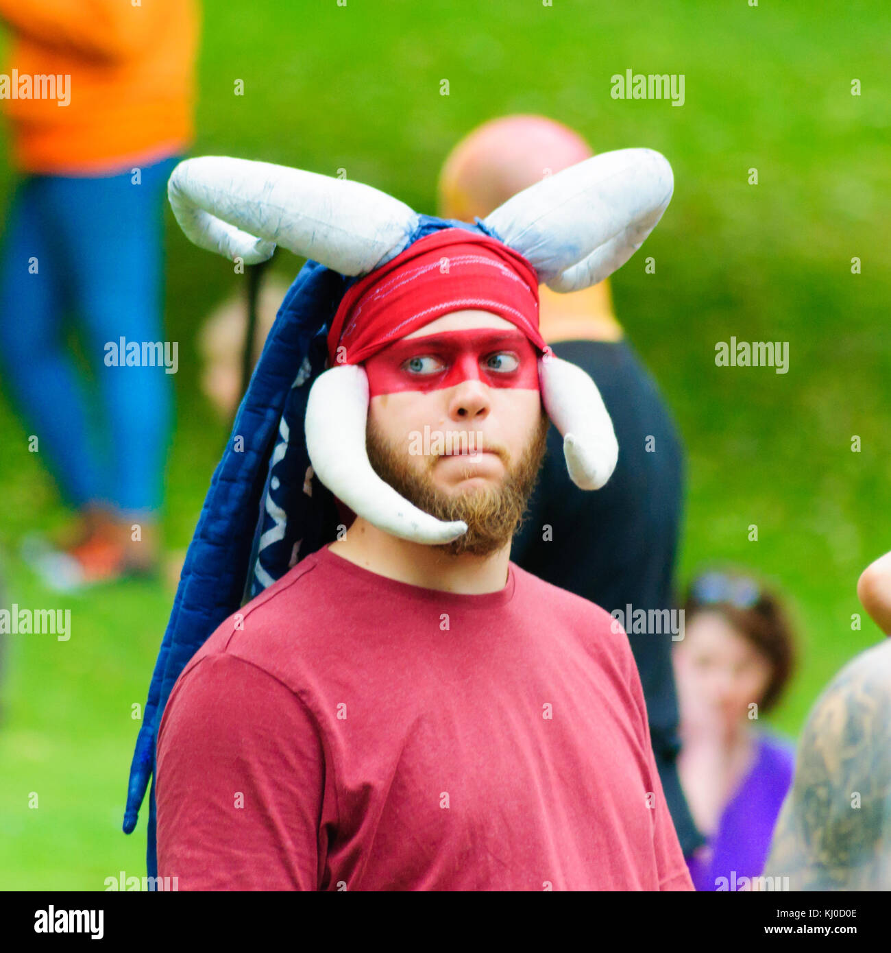 Male Performer With A Beard Red Paint Across Eyes And Wearing A Headdress With Horns In The Carnival Of The Edinburgh Jazz And Blues Festival Male Performer With A Beard Red Paint Across Eyes And Wearing A Headdress With Horns In The Carnival Of The Edinburgh Jazz And Blues Festival