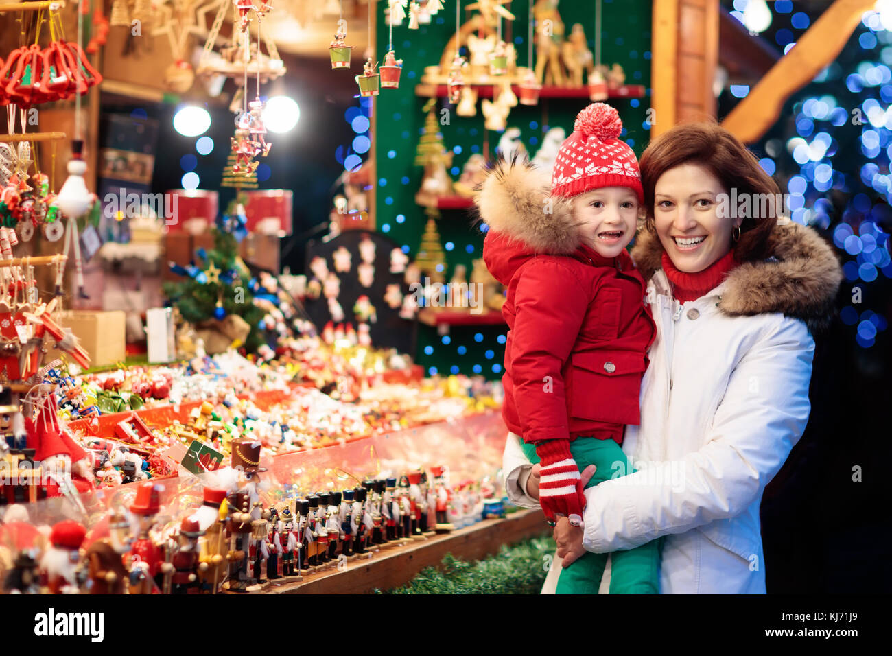 Traditional German Christmas Tree Ornaments Part - 18: Mother And Child In Warm Hat Watching Handmade Glass Christmas Tree Ornaments At Traditional German Xmas Street Market. Family With Child Shopping For