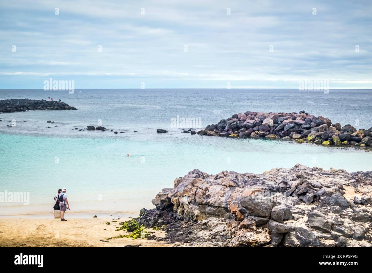 Couple Of Tourists On The Beach At Lanzarote Island In Spain This Photo Was Finalist Of The Biggest Photography Competition Of The World Organisez Couple Of Tourists On The Beach At Lanzarote Island In Spain This Photo Was Finalist Of The Biggest Photography Competition Of The World Organisez