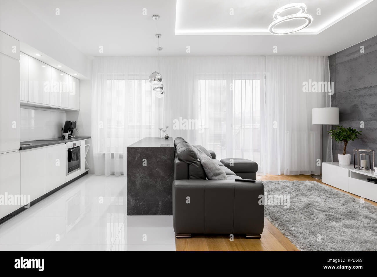white kitchen and living room in modern luxurious apartment stock
