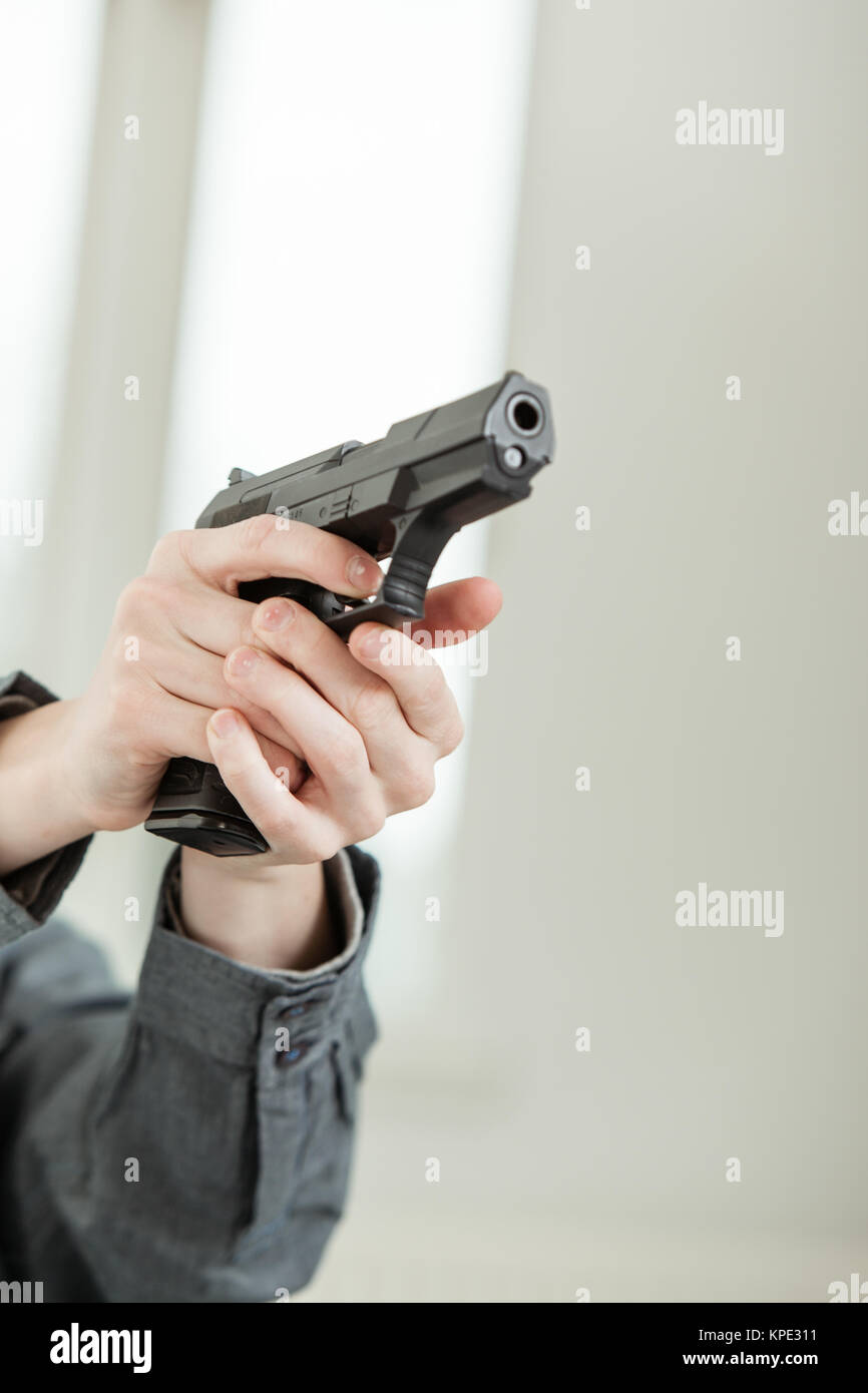 Hand Holding A Gun Pointing Away At Camera Stock Photo Alamy