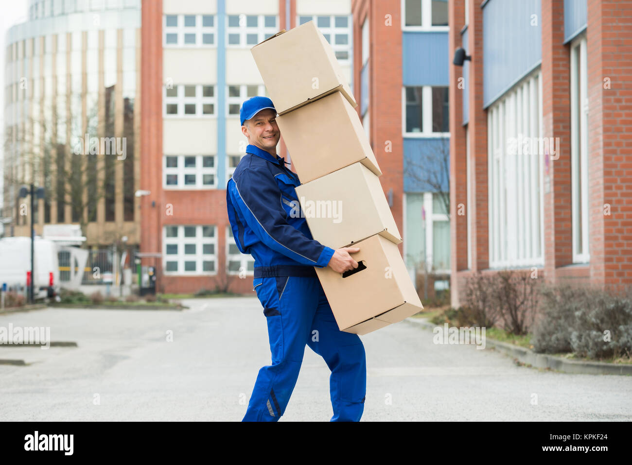 Delivery Man Carrying Cardboard Box Stock Photo Alamy