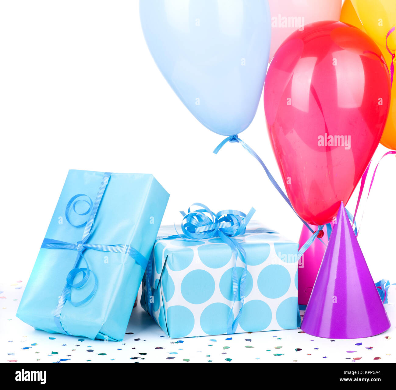 blue birthday gifts with balloons and party hats on a white stock
