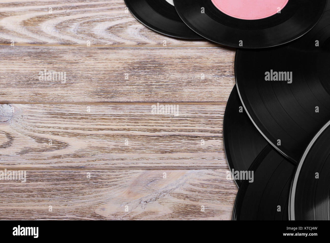 Top View Of Black Vinyl Records On Brown Wooden Background Retro Toned Copy Space Top View Of Black Vinyl Records On Brown Wooden Background Retro Toned Copy Space