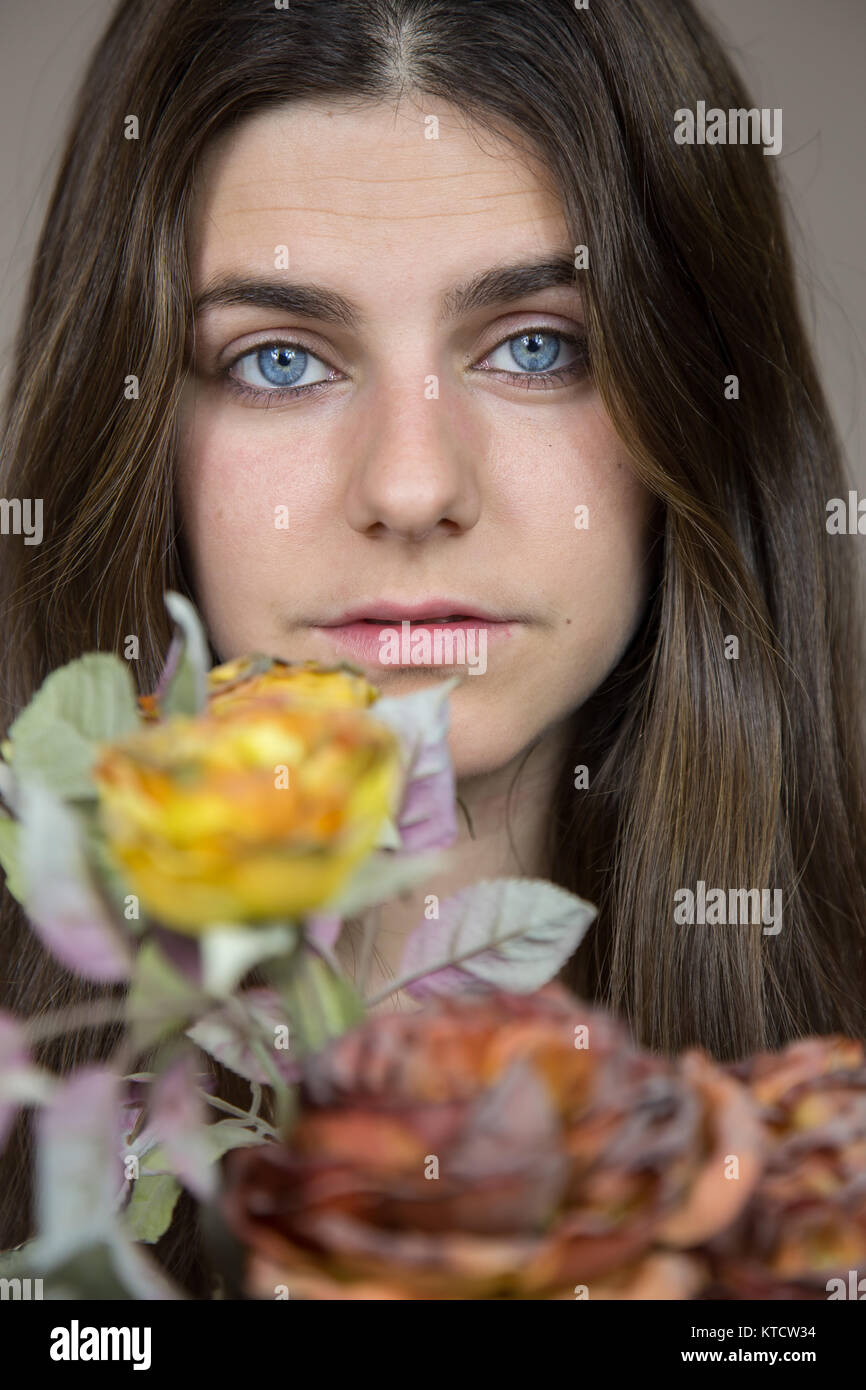 Portrait Of A Beautiful Young White Girl With Blue Eyes And Brown