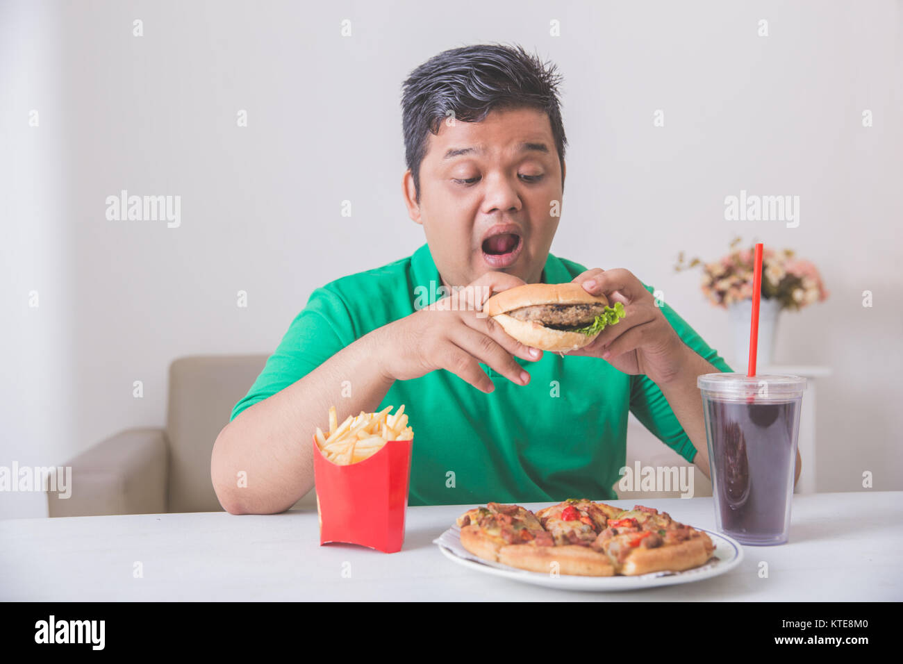 Obese Man Eating Junk Food Stock Photo Alamy