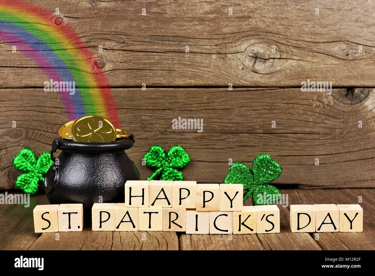 Happy St Patricks Day Wooden Blocks With Pot Of Gold Rainbow And Shamrocks Against Rustic Wood