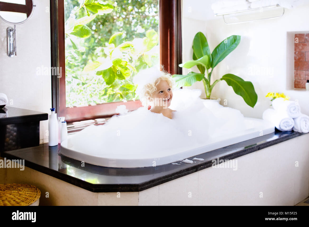 Little Child Taking Bubble Bath In Beautiful Bathroom With Big