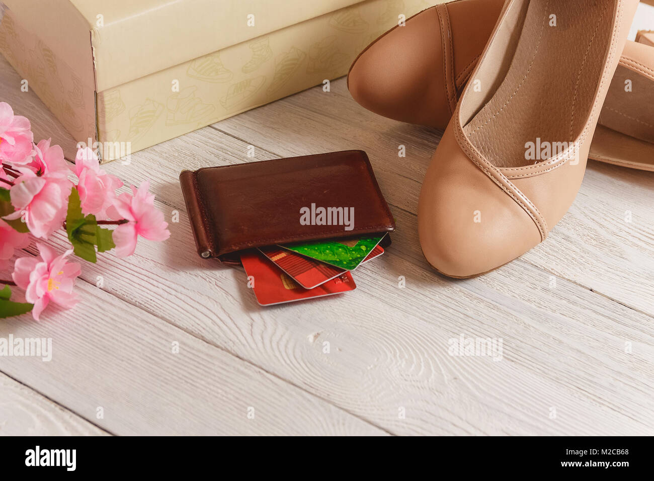 Box Wallet Credit Cards And Womans Shoes Lying On The White