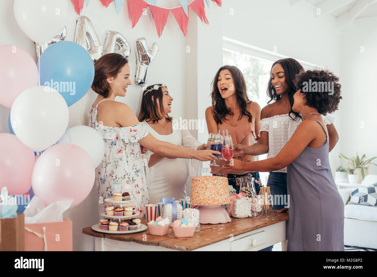 Women Toasting With Juices At Baby Shower Party Group Of Friends At