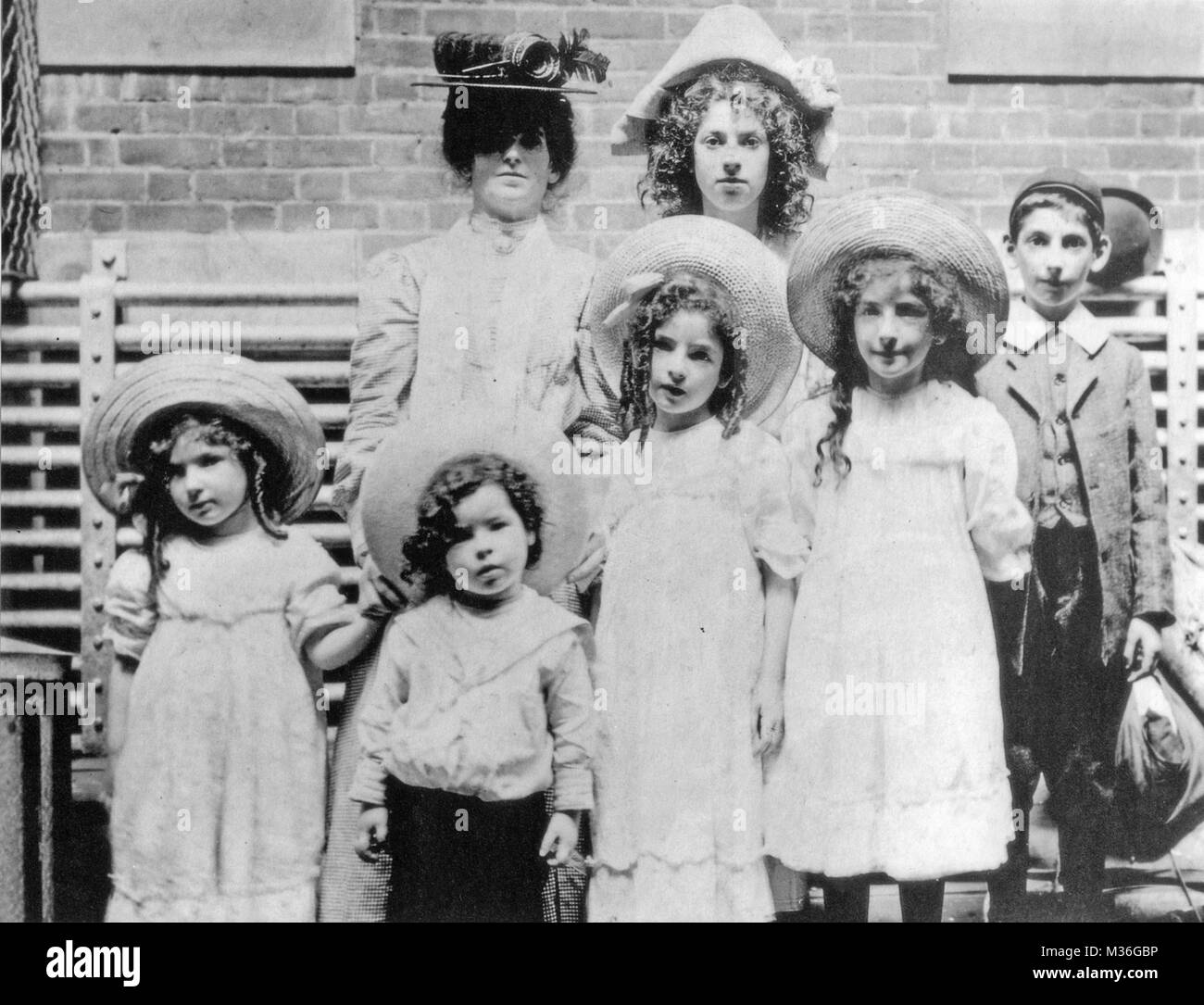 JEWISH IMMIGRANT FAMILY arrive on Ellis Island, New York, about 1905