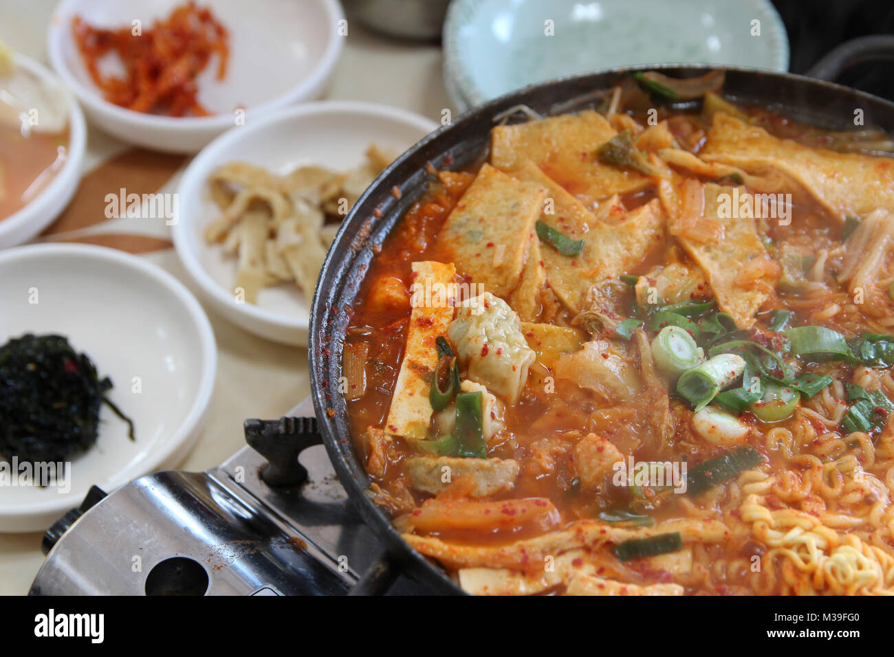 Close Up Of Korean Army Stew Budae Jjigae Hot Pot With The Side