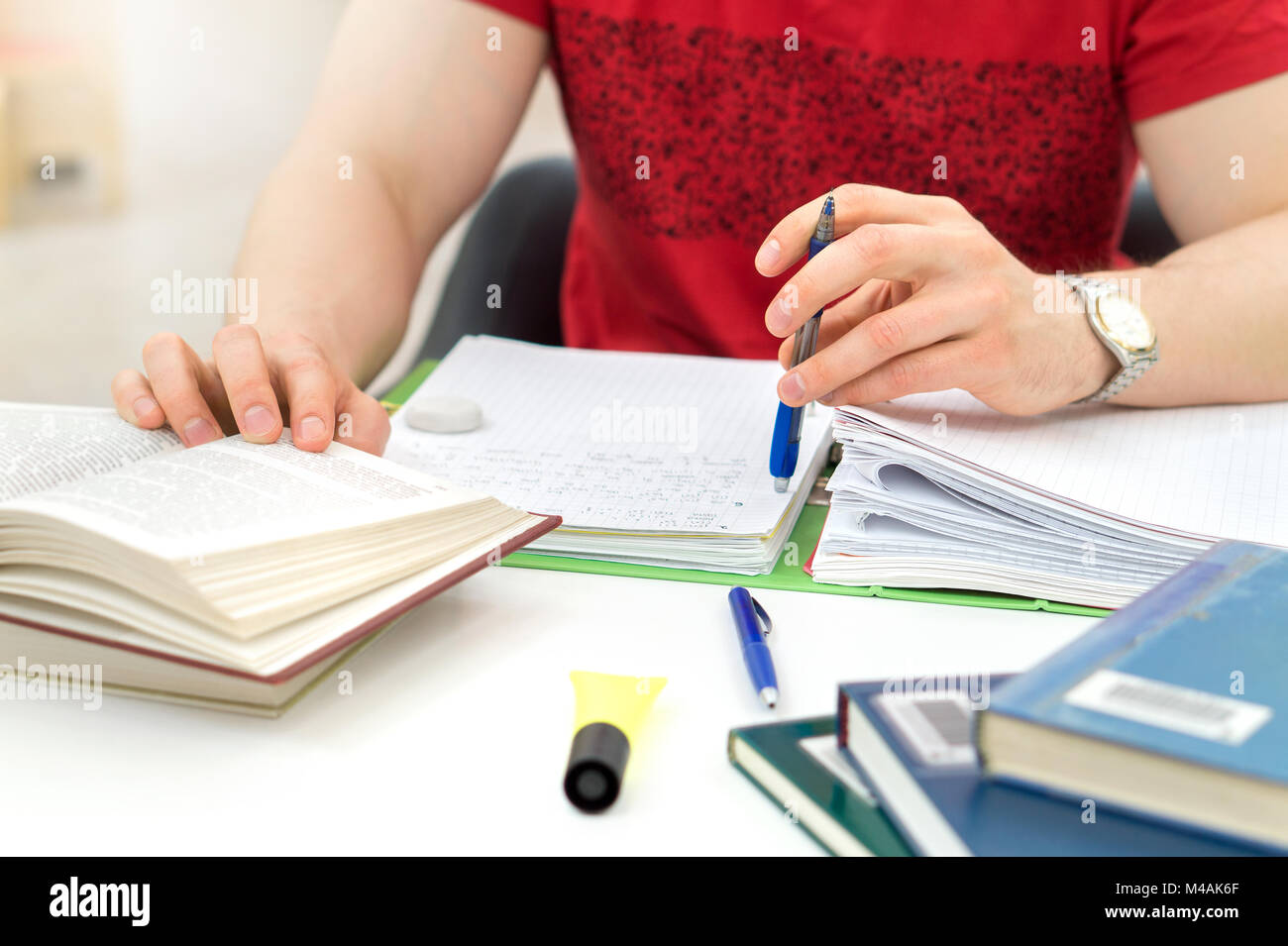 Student writing paper young