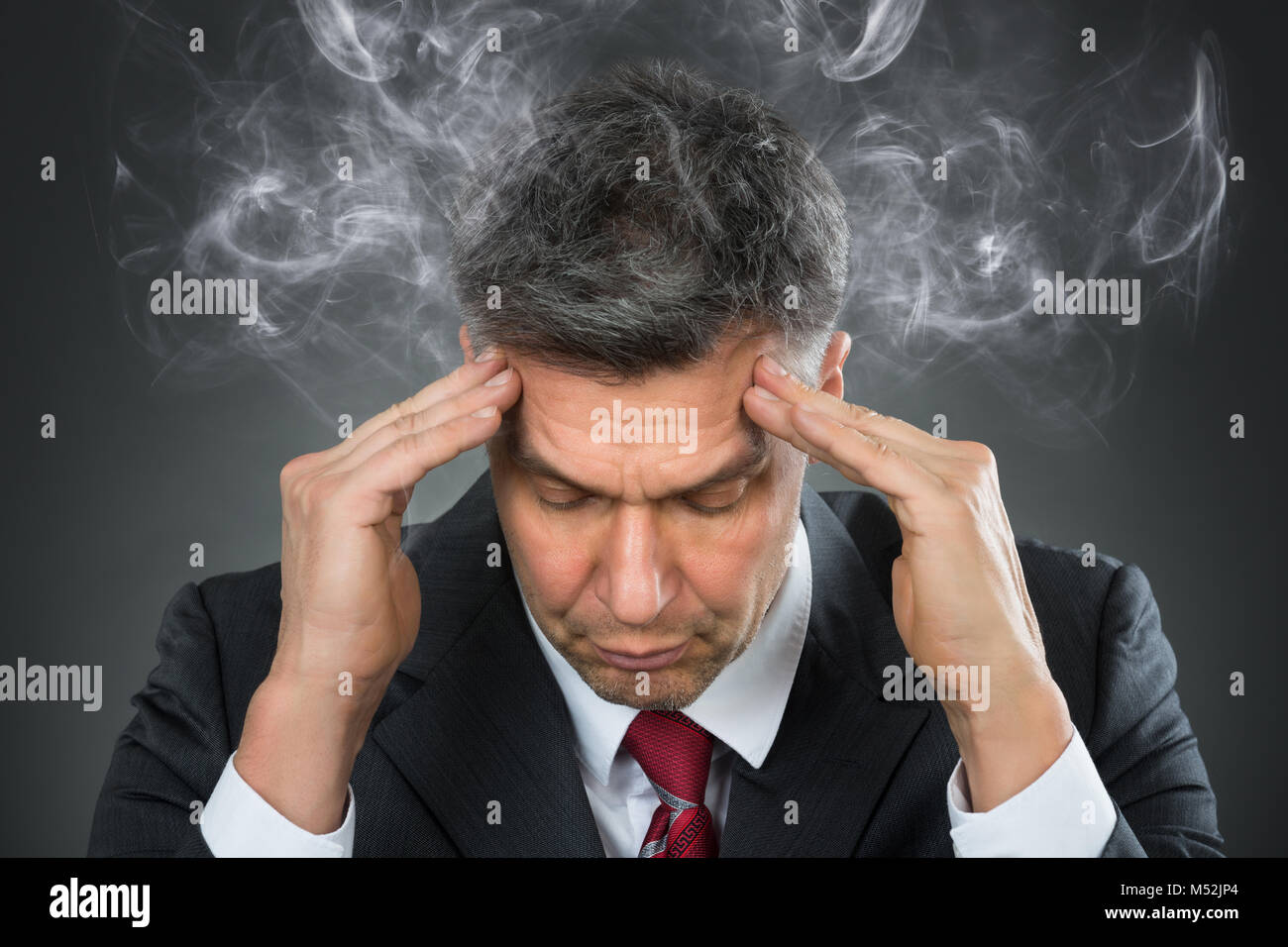 Portrait Of Mature Businessman Suffering From Headache Stock Photo Alamy