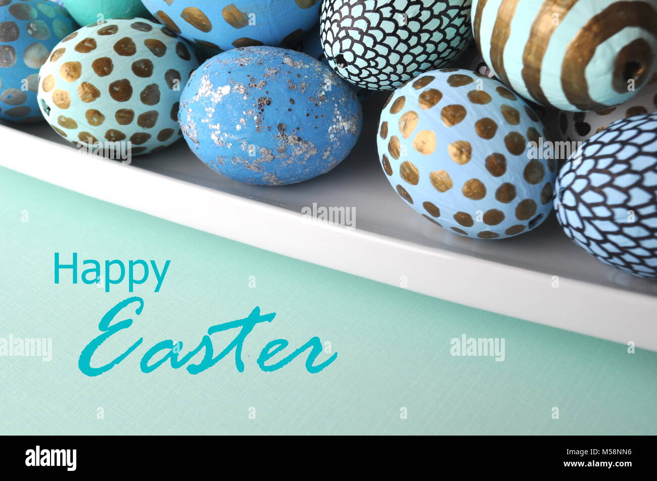 Modern decorated Easter eggs on solid pastel background with copy Stock