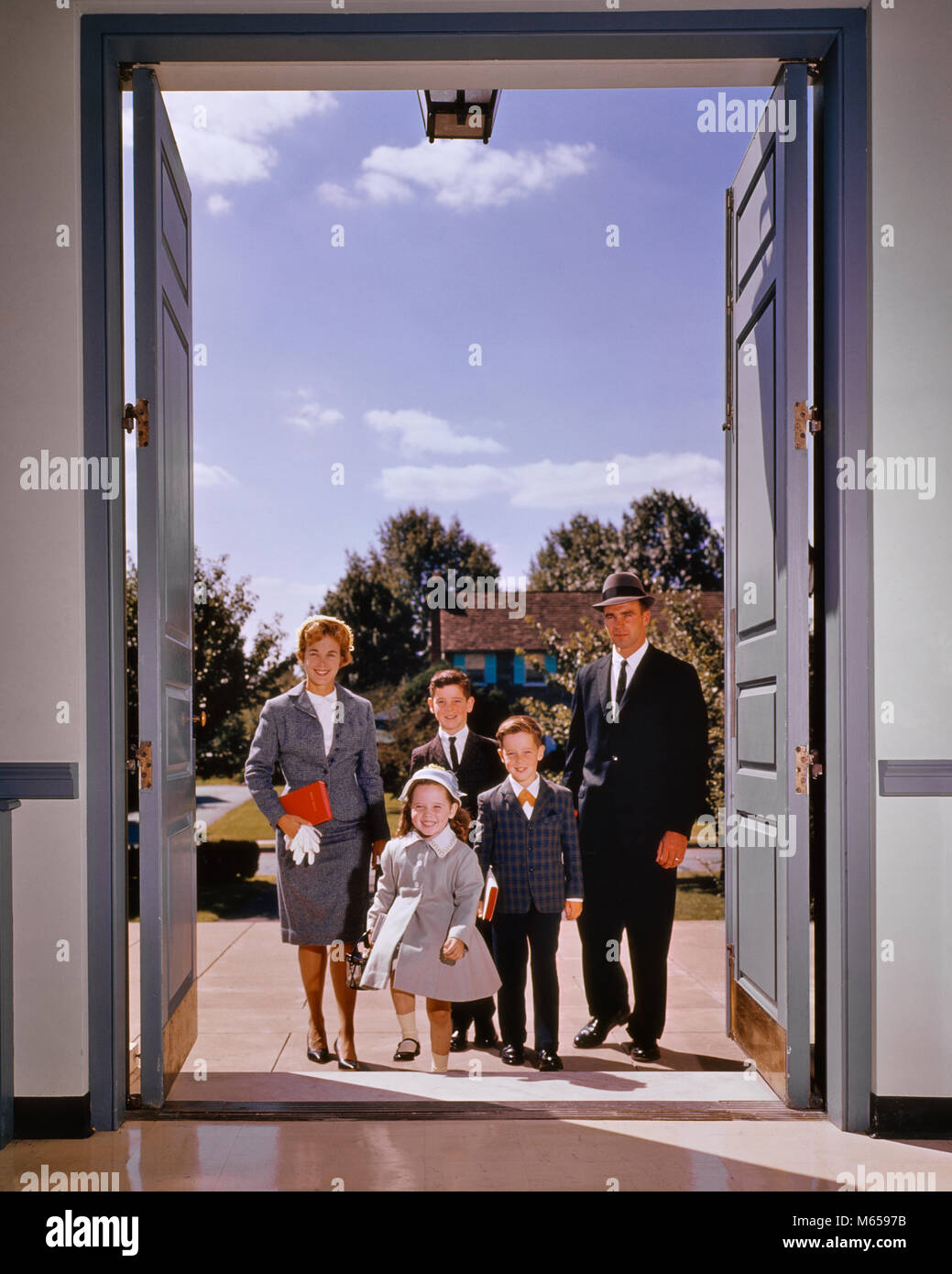 1960s FAMILY OF FIVE WALKING IN THE FRONT DOOR OF CHURCH LOOKING AT ... 1960s FAMILY OF FIVE WALKING IN THE FRONT DOOR OF CHURCH LOOKING AT ...