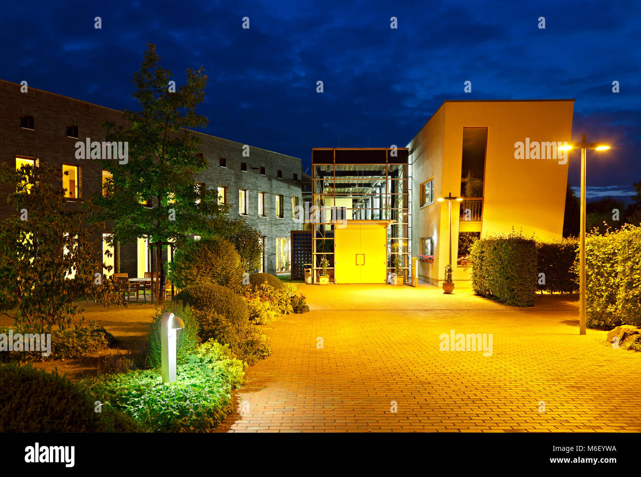 Modern architecture of a small clinic building at night.