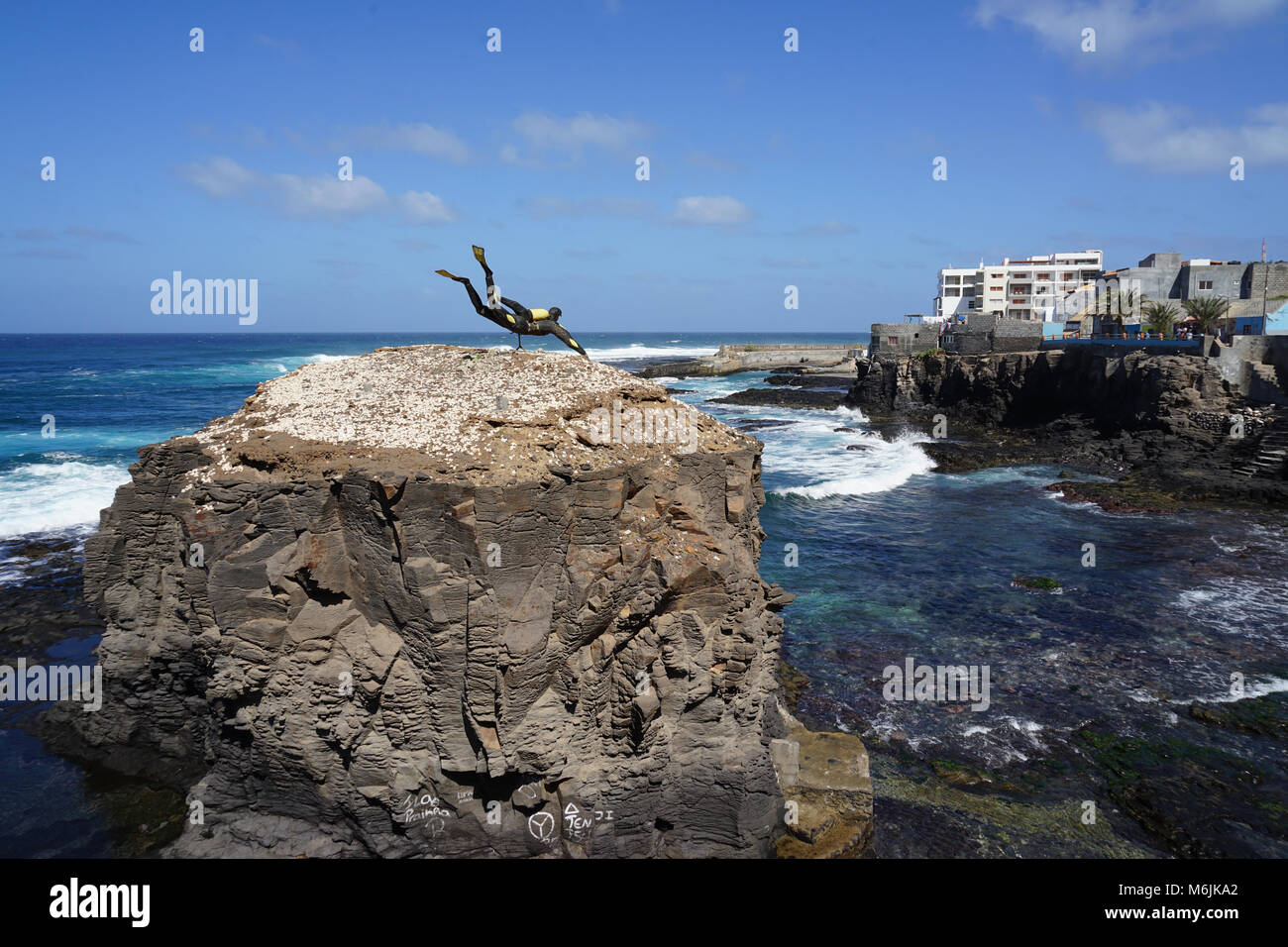 scuba diver statue on a rock facing the sea ponta do sol santo