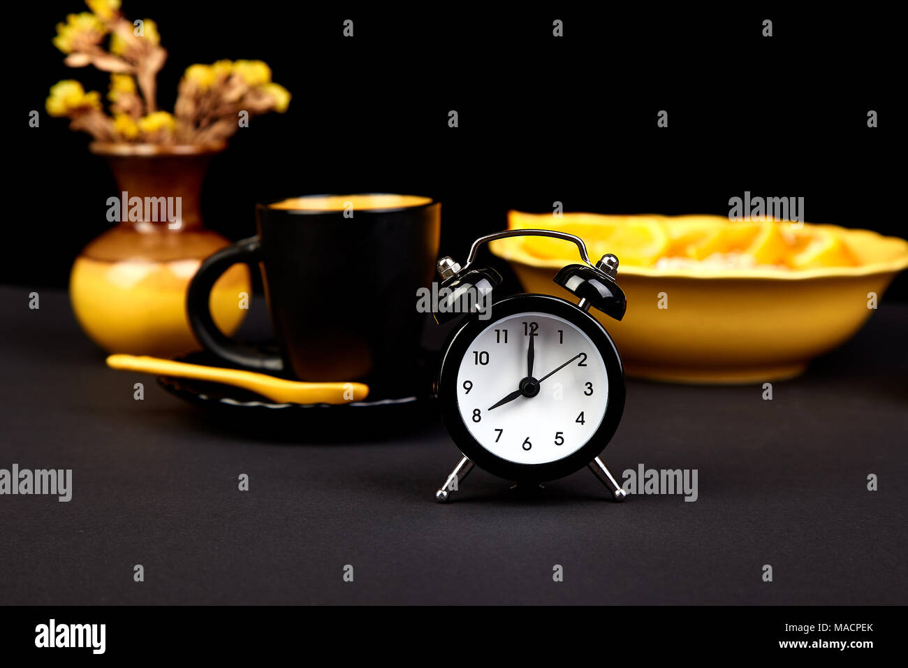 morning coffee granola breakfast with fruit near alarm clock