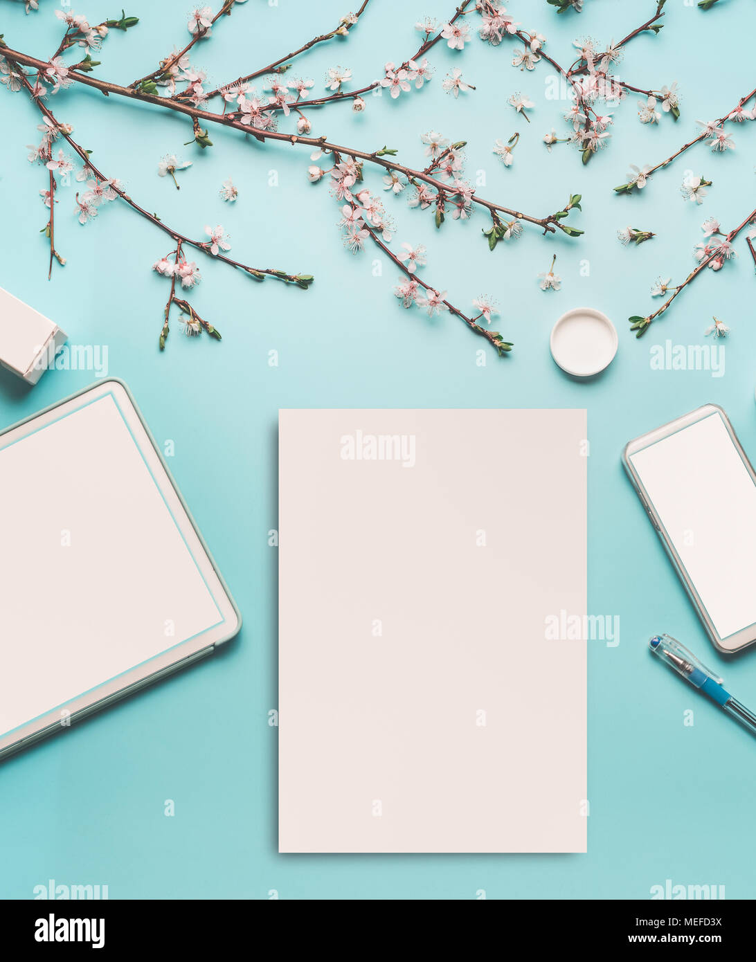 Spring Background With Cherry Blossom Twigs On Blue Desktop Top View