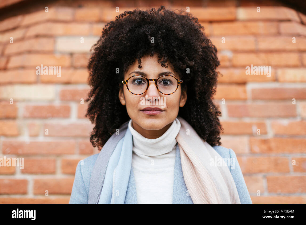 Portrait Of Serious Woman At Brick Wall Stock Photo Alamy