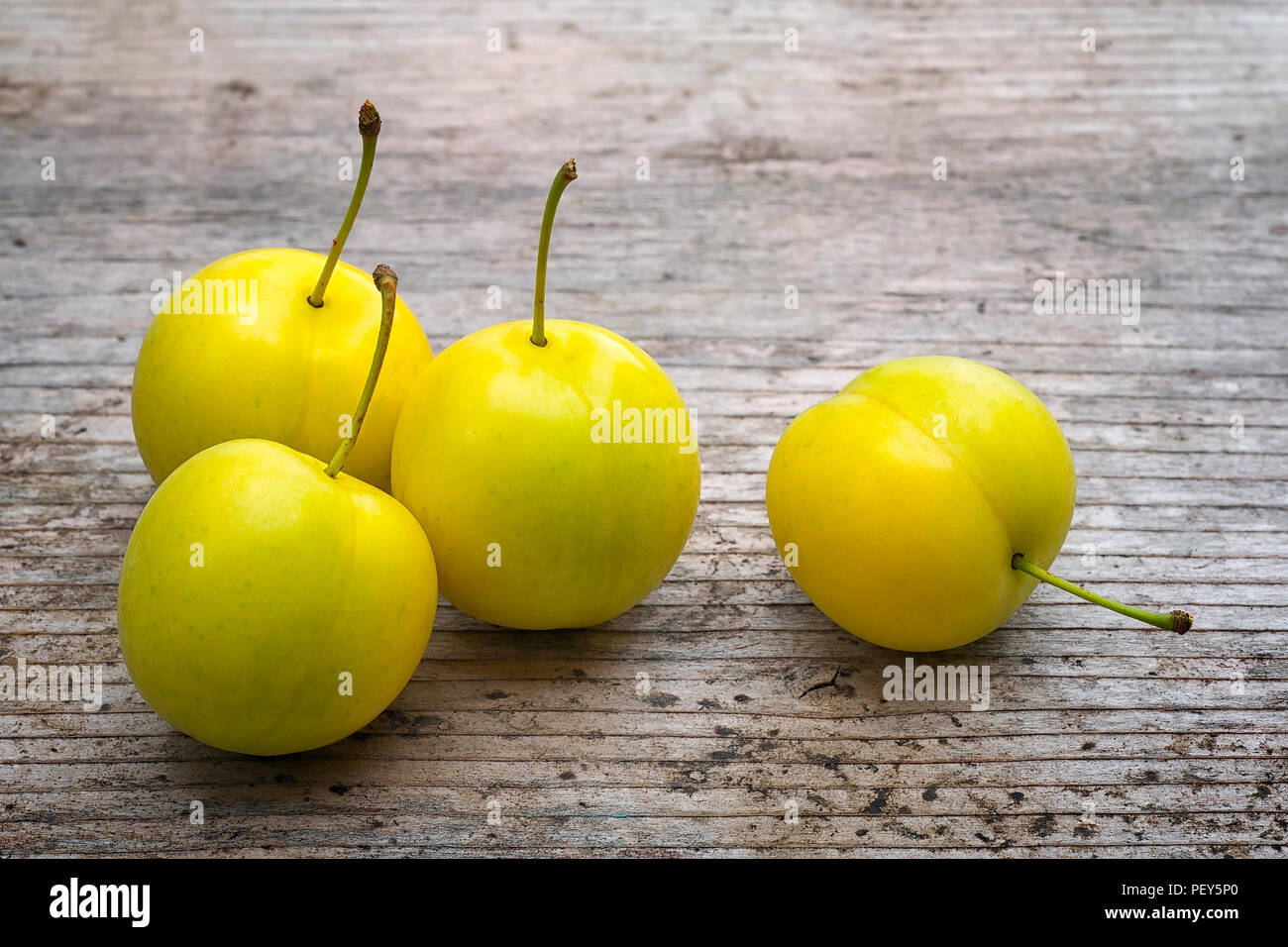 Yellow Cherry Plum Prunus Cerasifera Ripe Of Fruit On Woody Table