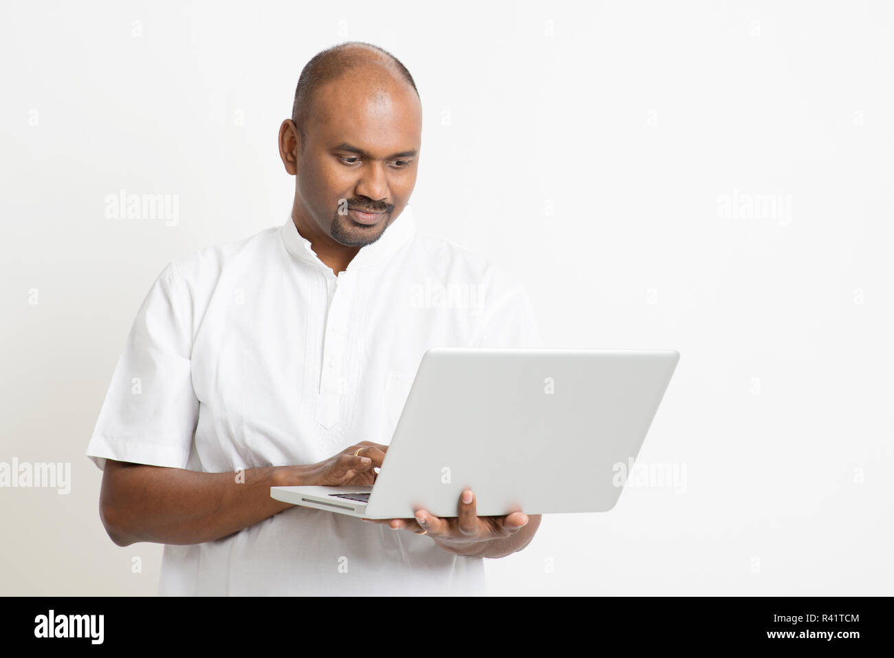Mature Indian Man Using Laptop Stock Photo Alamy