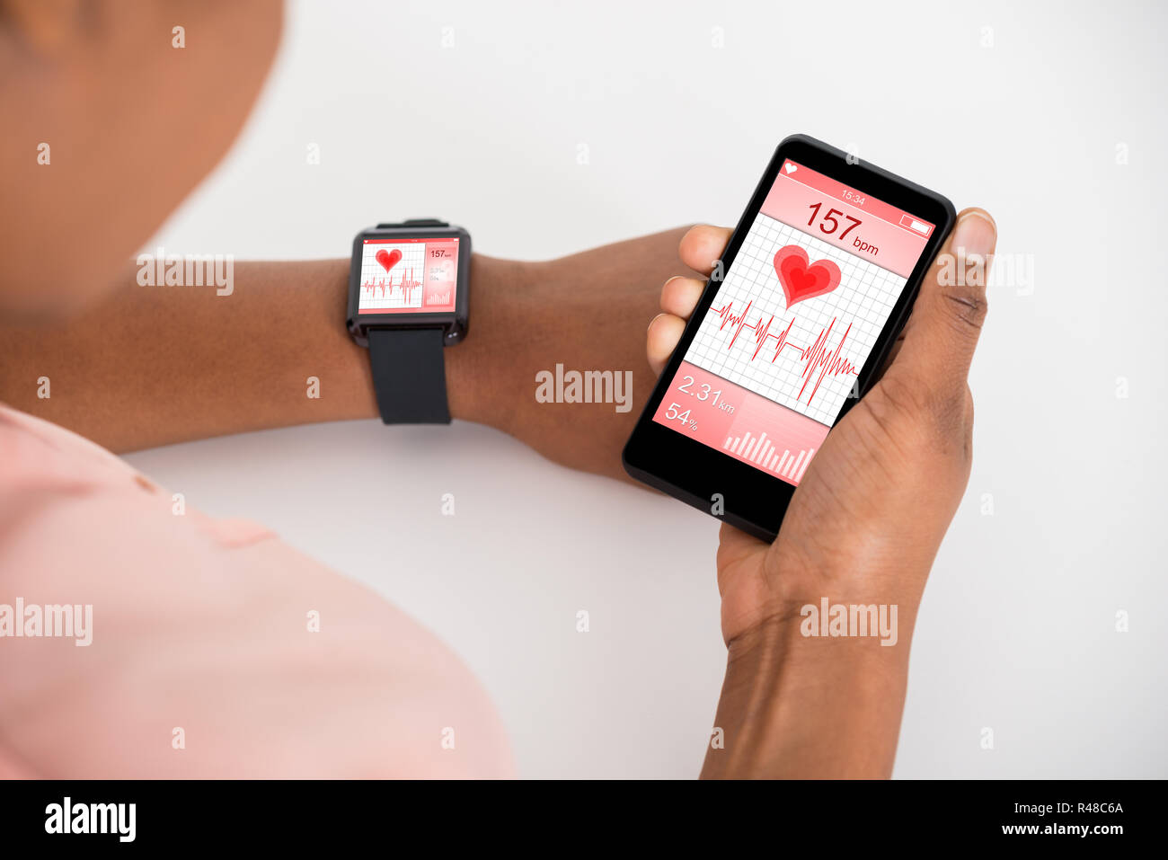 Hand With Mobile And Smartwatch Showing Heartbeat Rate Stock Photo Alamy