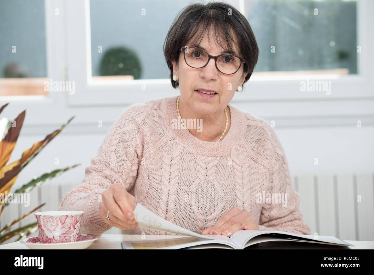 Mature Brunette Woman Reading Magazine Stock Photo Alamy