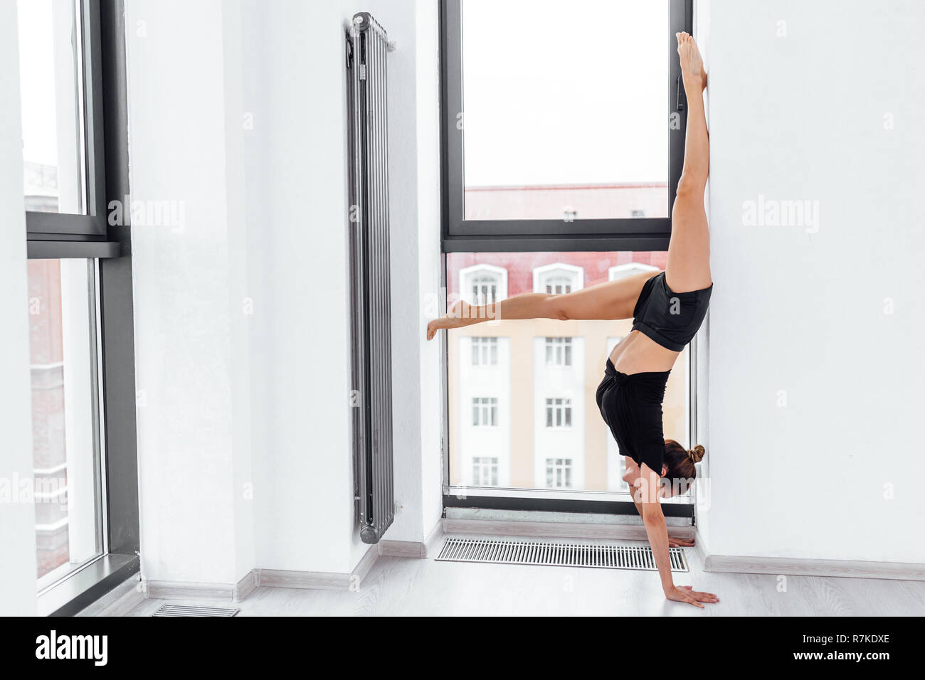 Yong Fit Woman Standing Upside Down During Pilates Training Stock Photo