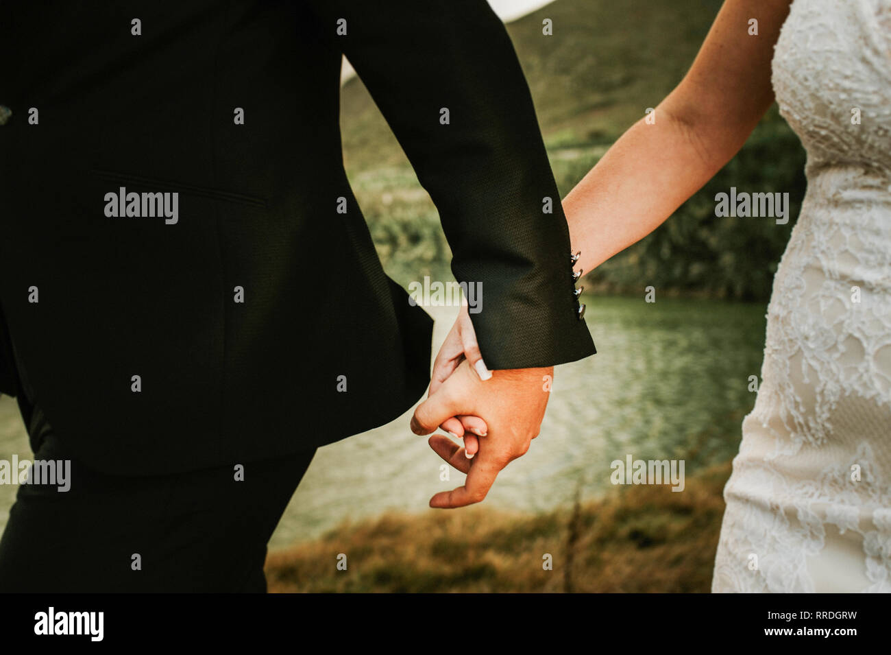 Faceless Man And Woman Wearing Wedding Garments And Holding Hands While