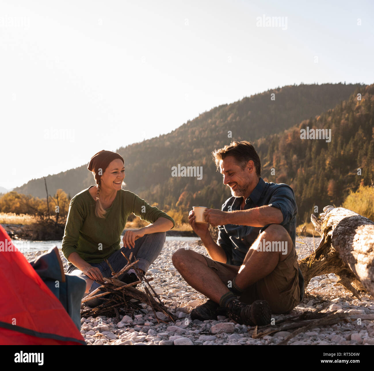 Mature Couple Camping At Riverside In The Evening Light Stock Photo Alamy