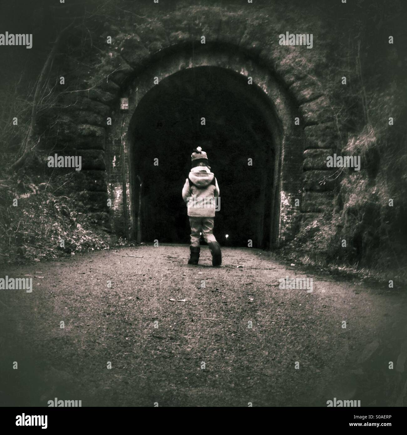 Boy entering tunnel alone Stock Photo, Royalty Free Image 310017786 Alamy