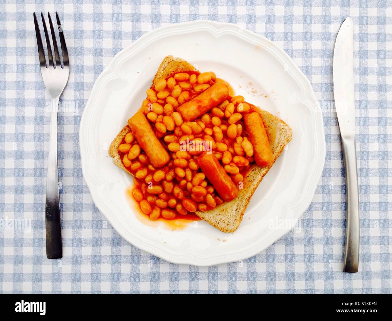 Heinz baked beans and pork sausages on toast Stock Photo, Royalty Free