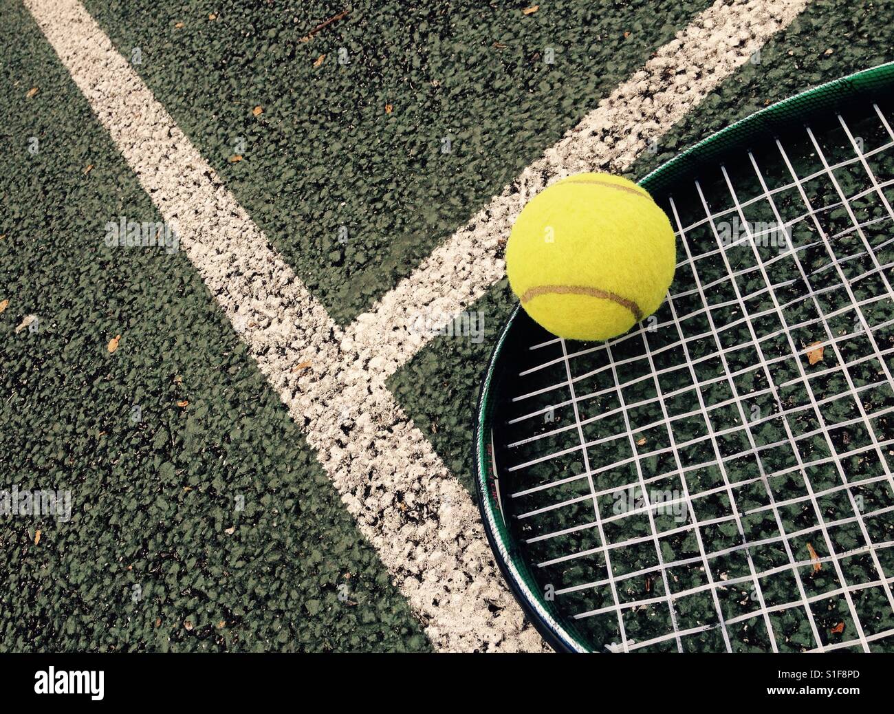 Tennis racket and ball on tennis court Stock Photo, Royalty Free Image